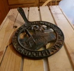 Vermont Castings Iron Trivet With Handle, Plant Scene. Fixed Price $45.00.